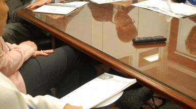 CEC advocates sitting around legislative table with issue briefs